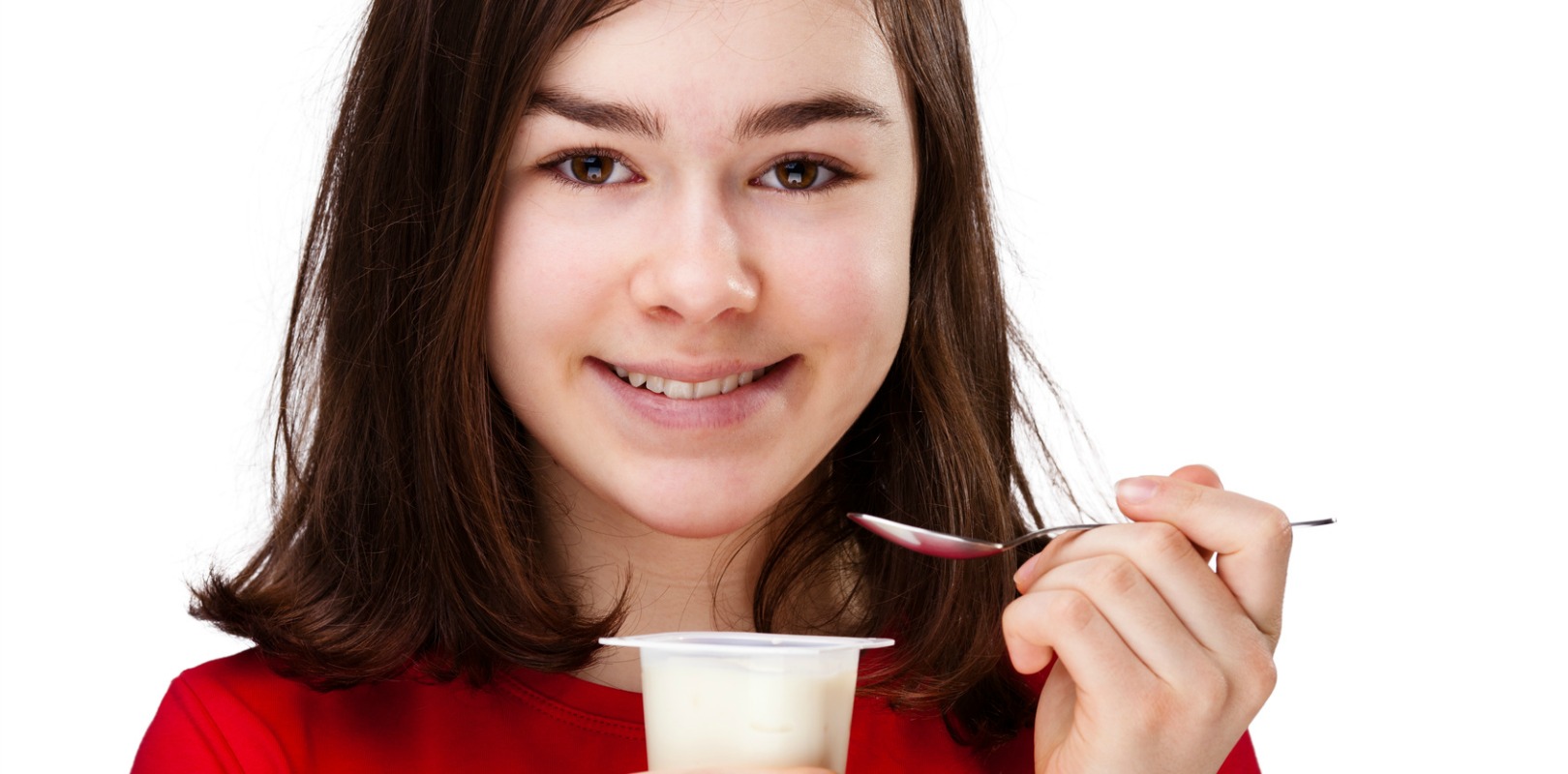 teenage girl eating yogurt